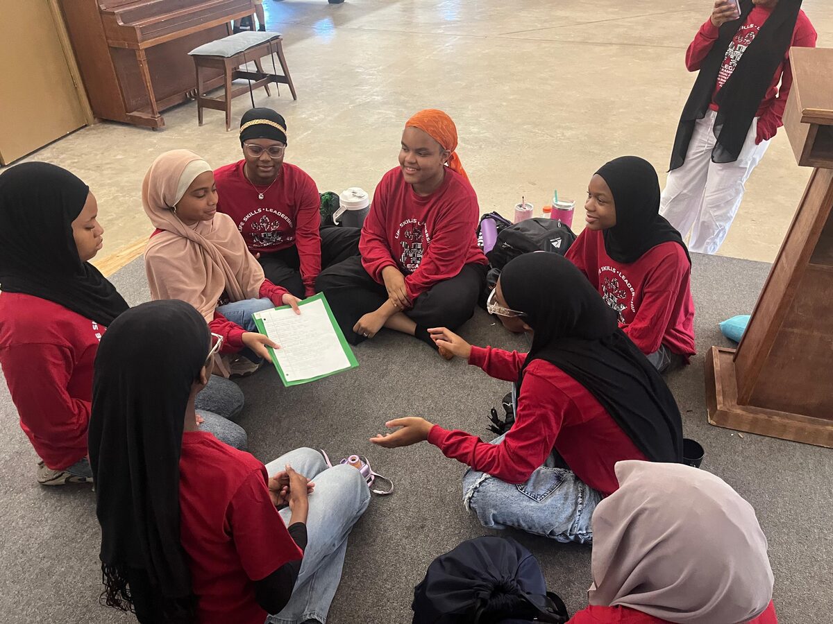 Young women in group discussion at Kamp Khalil