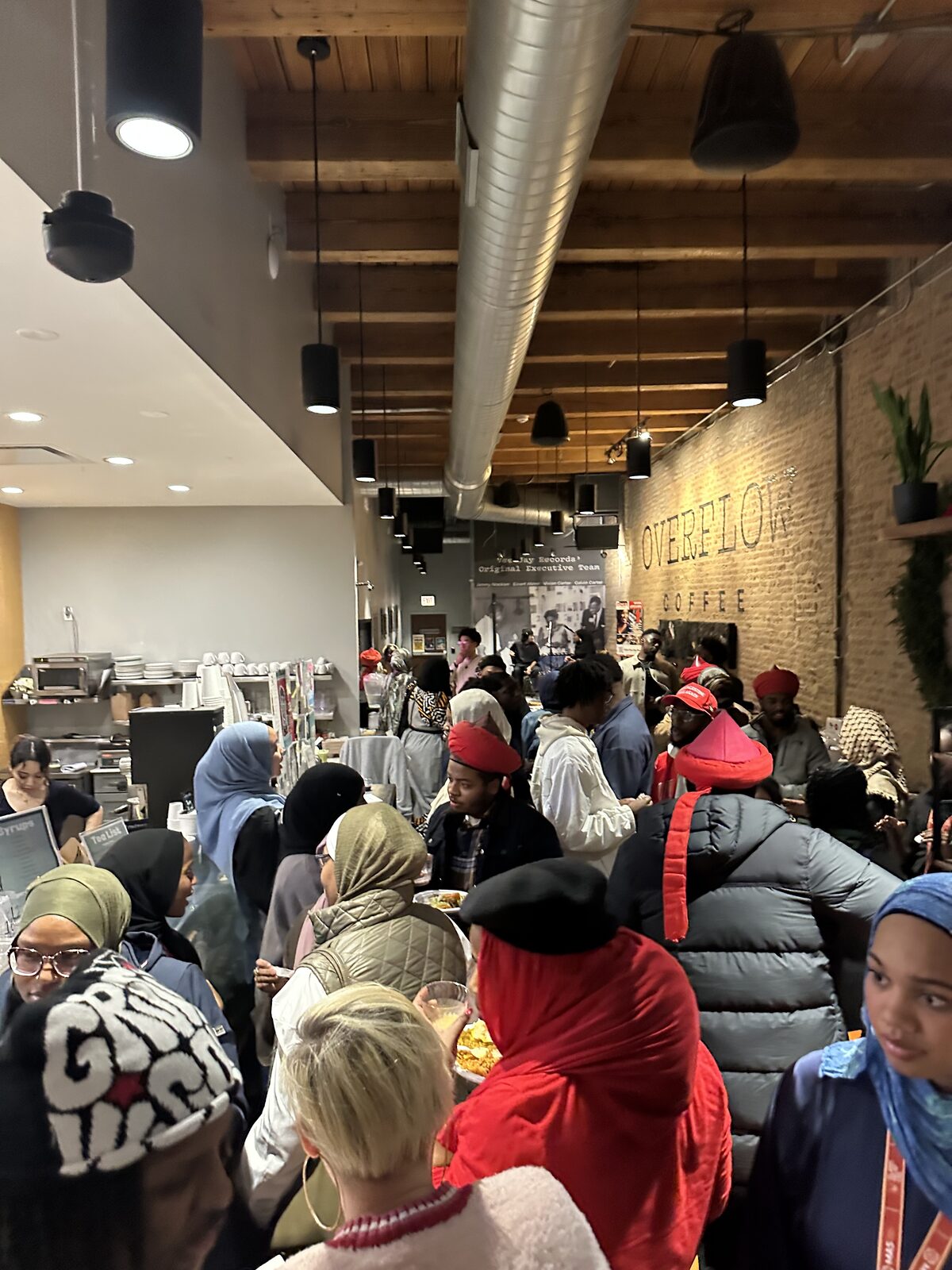 Crowded social gathering at Overflow Coffee