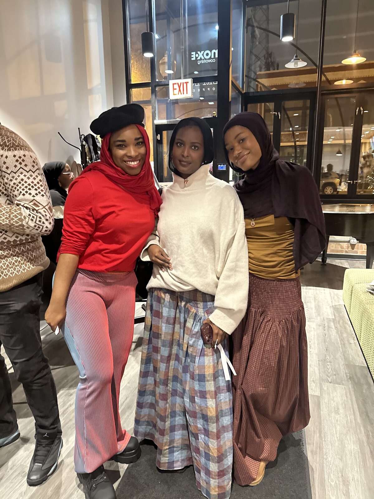 Three women posing at the social event